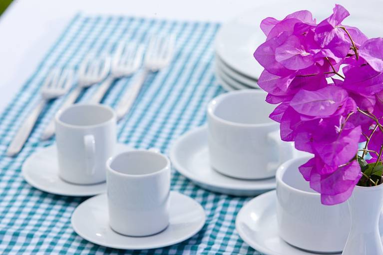 Bougainvilleas and white cups lined up for your morning coffee at Galaxy Villas during your villa holidays in Crete