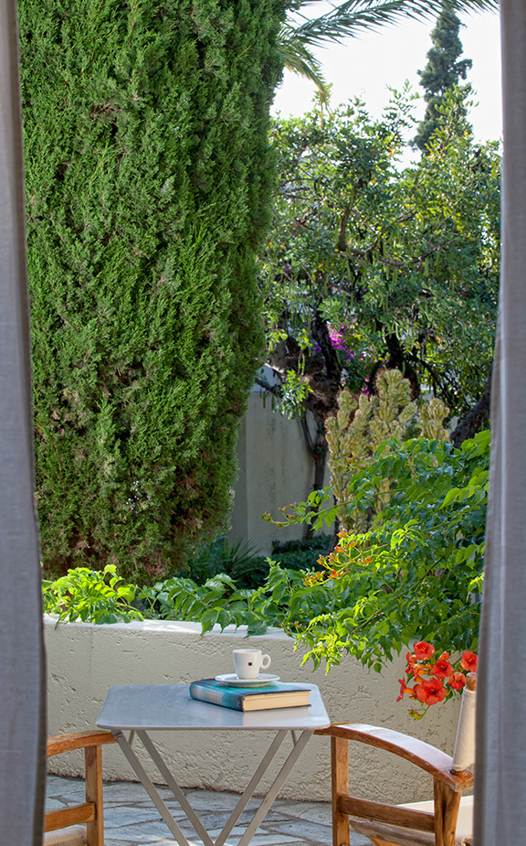 Terrace setting within the verdant gardens of Pool of Galaxy Villas Crete, Villas & Apartments Resort in Hersonissos
