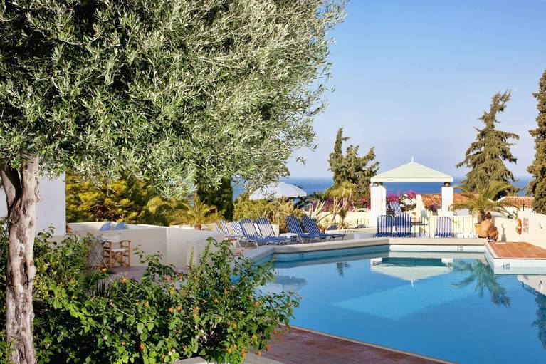 Pool and garden with sun loungers and parasols at Galaxy Villas in Koutouloufari, a lovely villa complex and family friendly hotel in Hersonissos